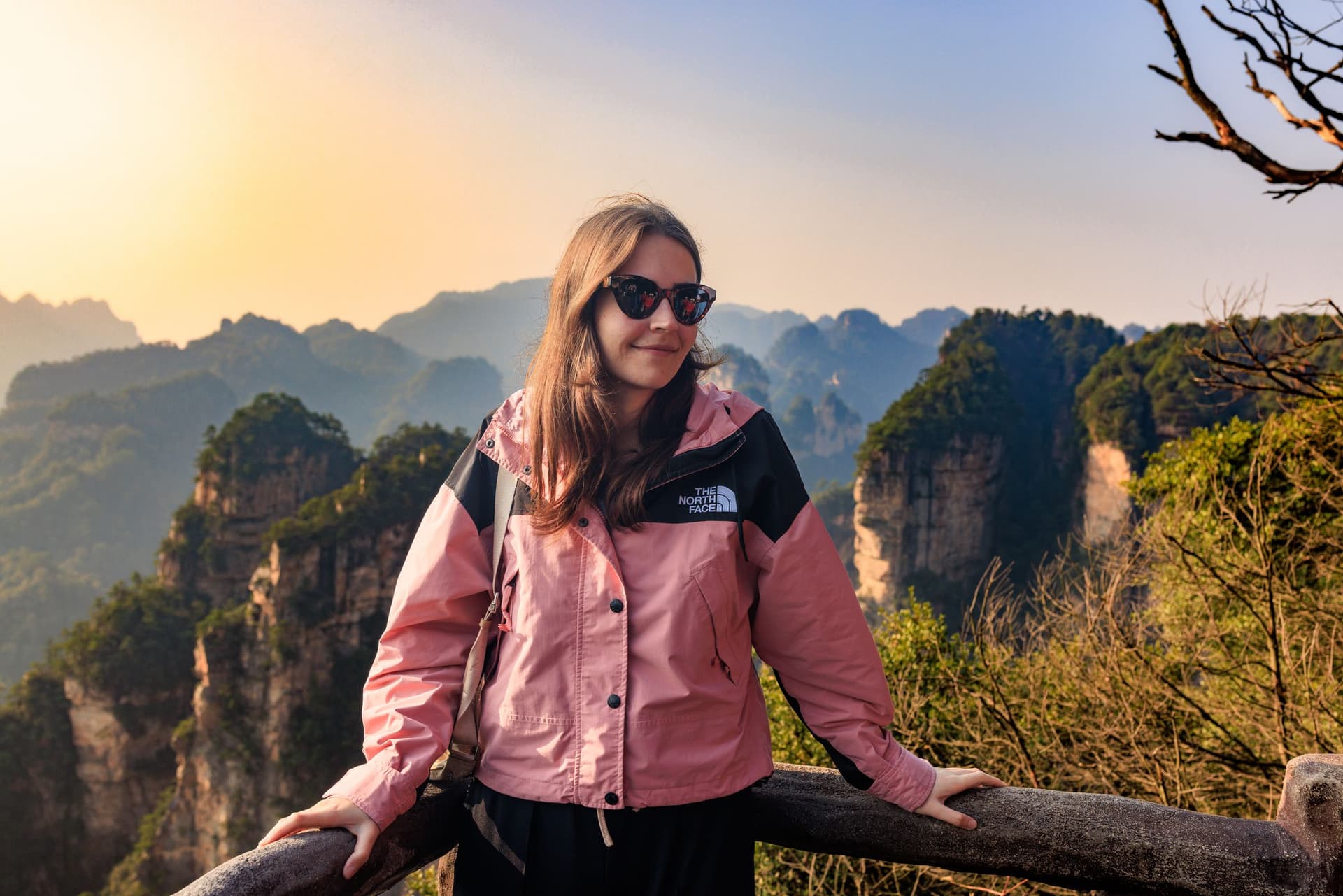 A traveler looking across the sandstone peaks of Zhangjiajie.